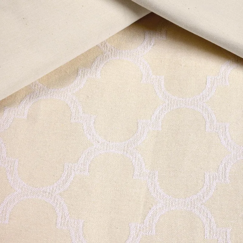 Fabric close-up of ivory bedsheet with white geometric motif