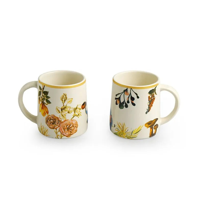 Two white ceramic tea cups with different floral motifs