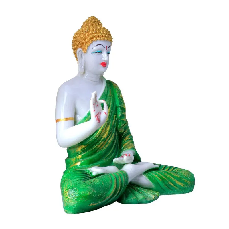 Side view of seated Buddha idol with green drape
