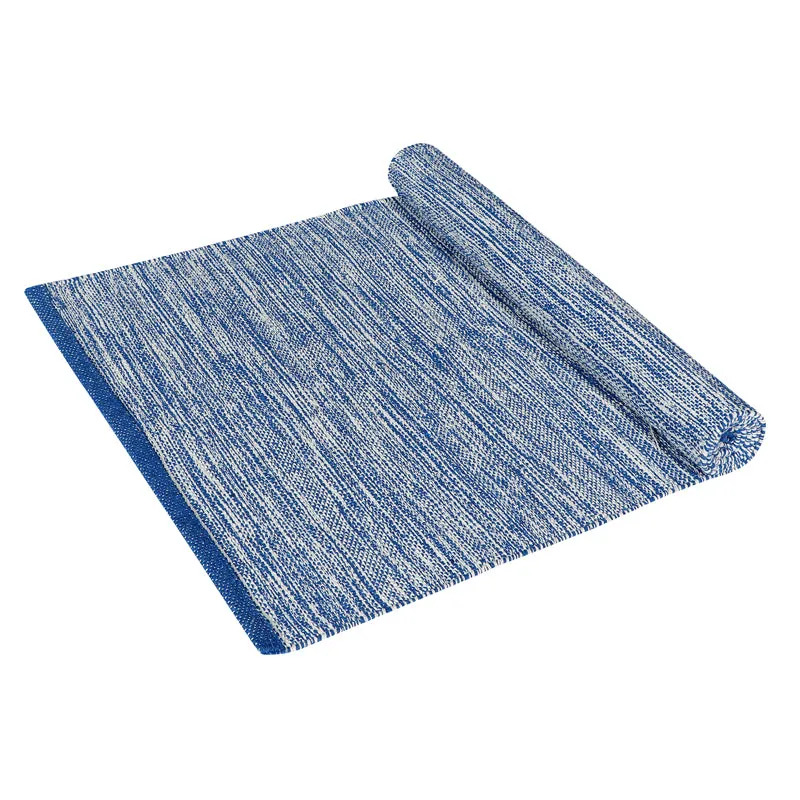 Blue rectangular runner rug partially rolled on a white background