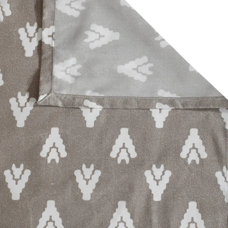Grey pillow cover fabric with small white motif and folded corner detail