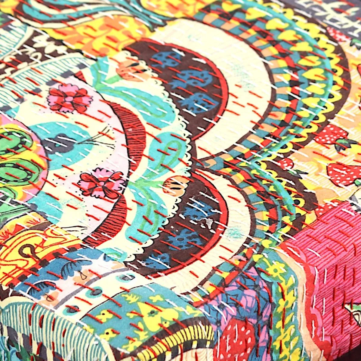 Close-up of colourful cushion fabric with floral and geometric motifs