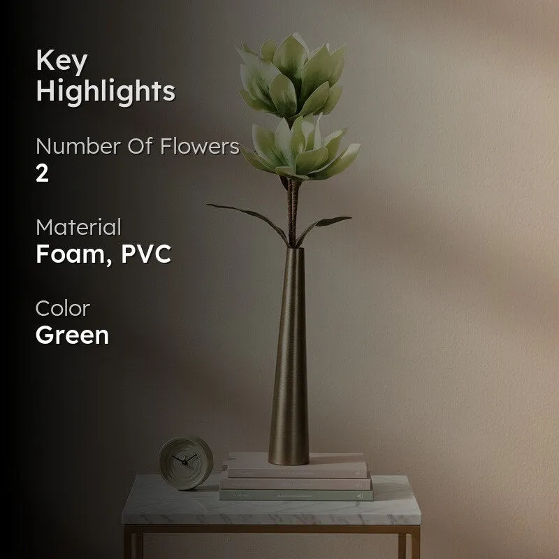 Green artificial flower stick styled in a tall metallic vase on a console table