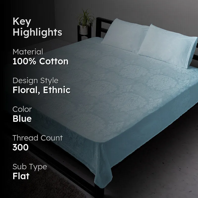Pale blue floral bedsheet on a bed in a dark-toned room setting