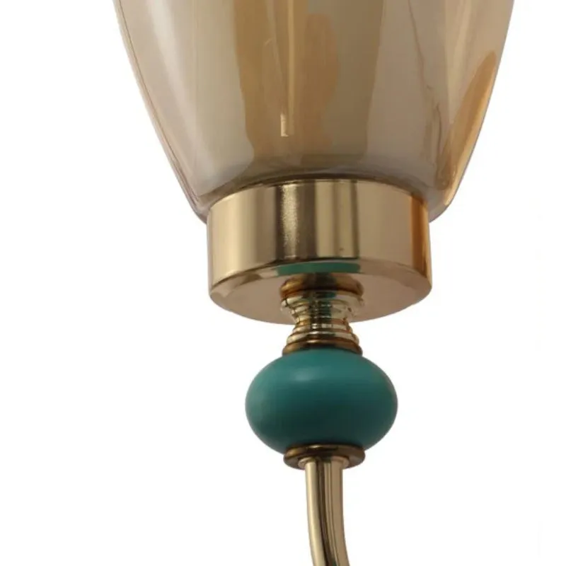 Close-up of the lamp base with gold-toned metal and teal accent detail