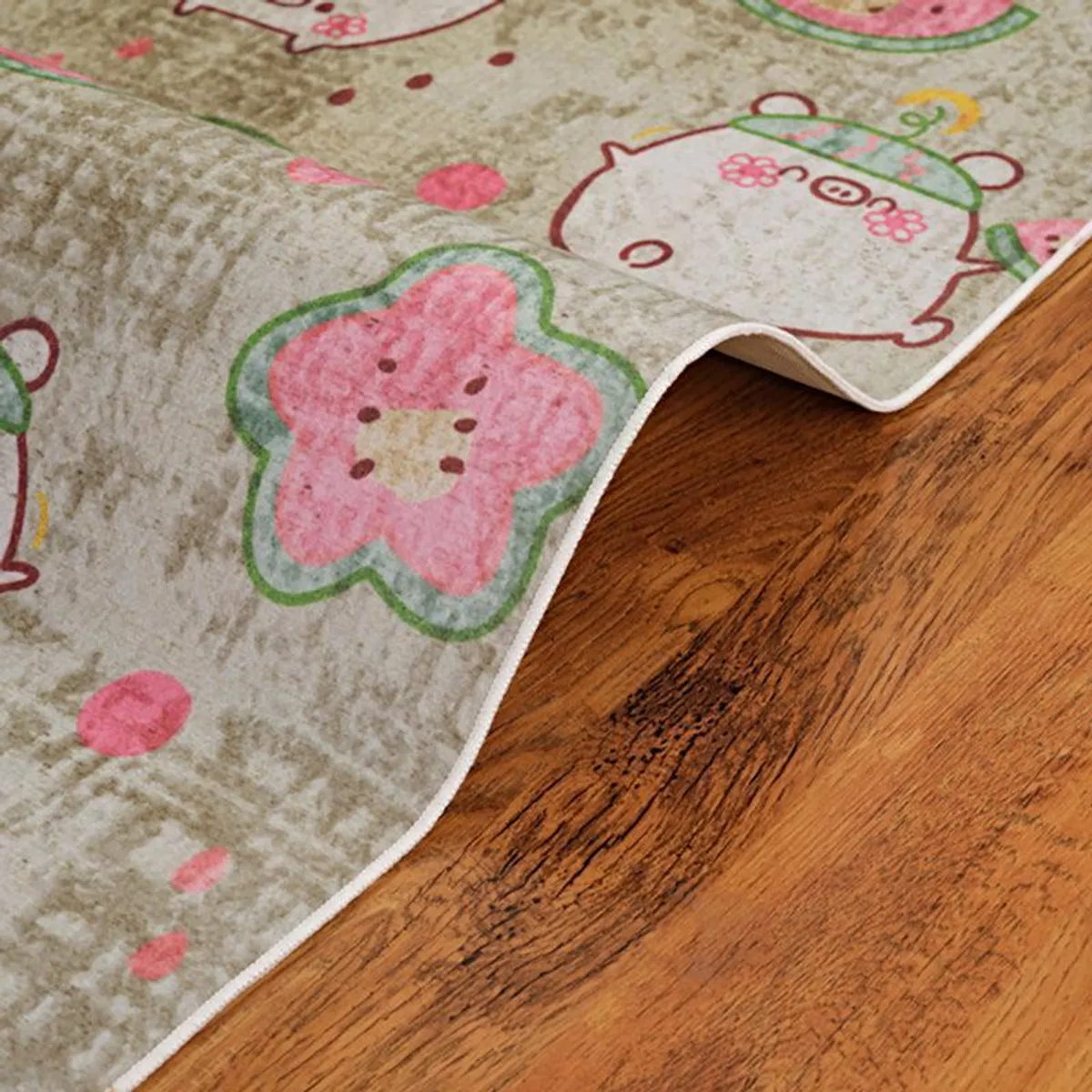 Curved edge detail of beige carpet with pink and green print
