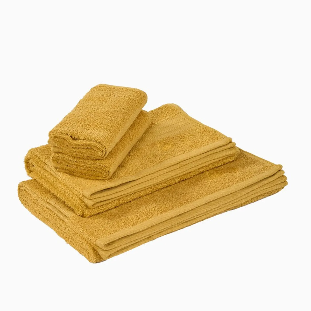 Stack of yellow towels including larger bath towels and smaller hand towels.