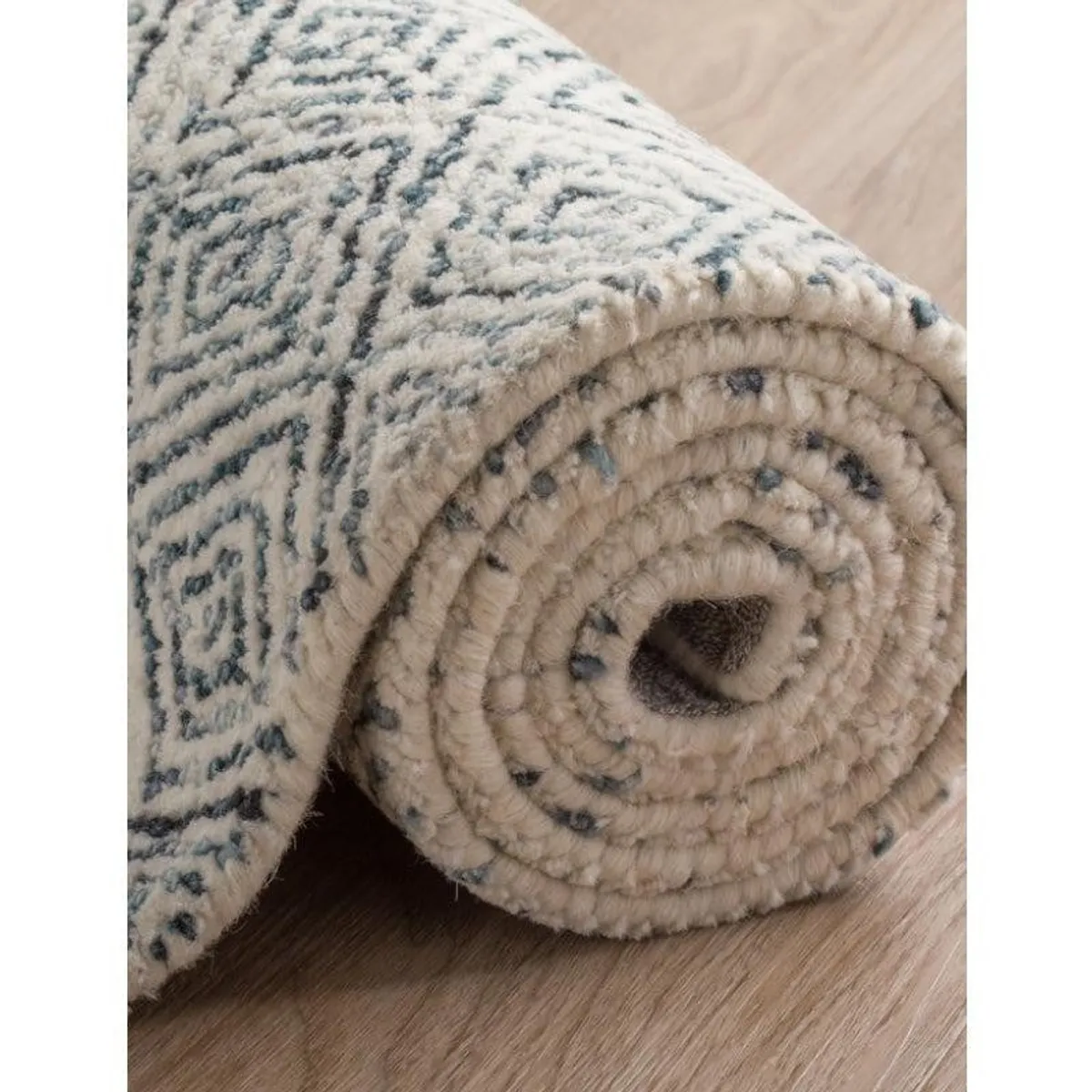 Rolled close-up showing the rug's soft textured pile