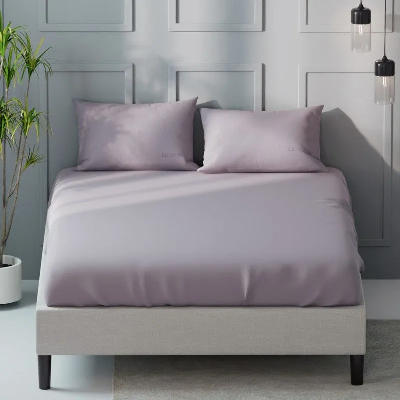 Front view of a light pink solid king bedsheet and two pillow covers