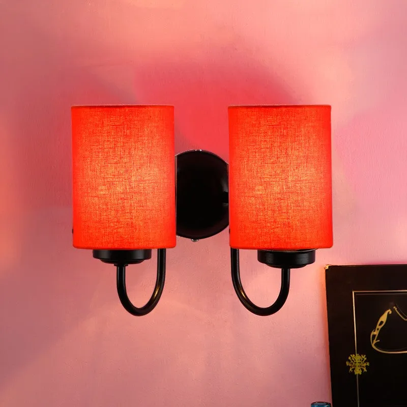 Front view of orange double wall lamp with black iron wall mount