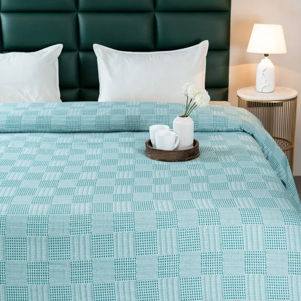 Close view of the bedsheet's geometric self-design texture on a bed