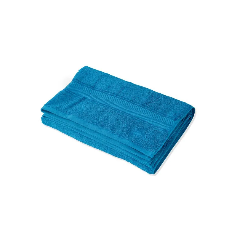 Folded vivid blue bath towel on a white background