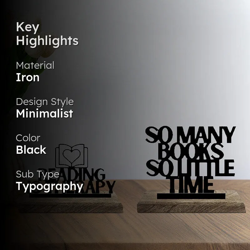 Two black typography showpieces styled on a wooden surface with an editorial overlay