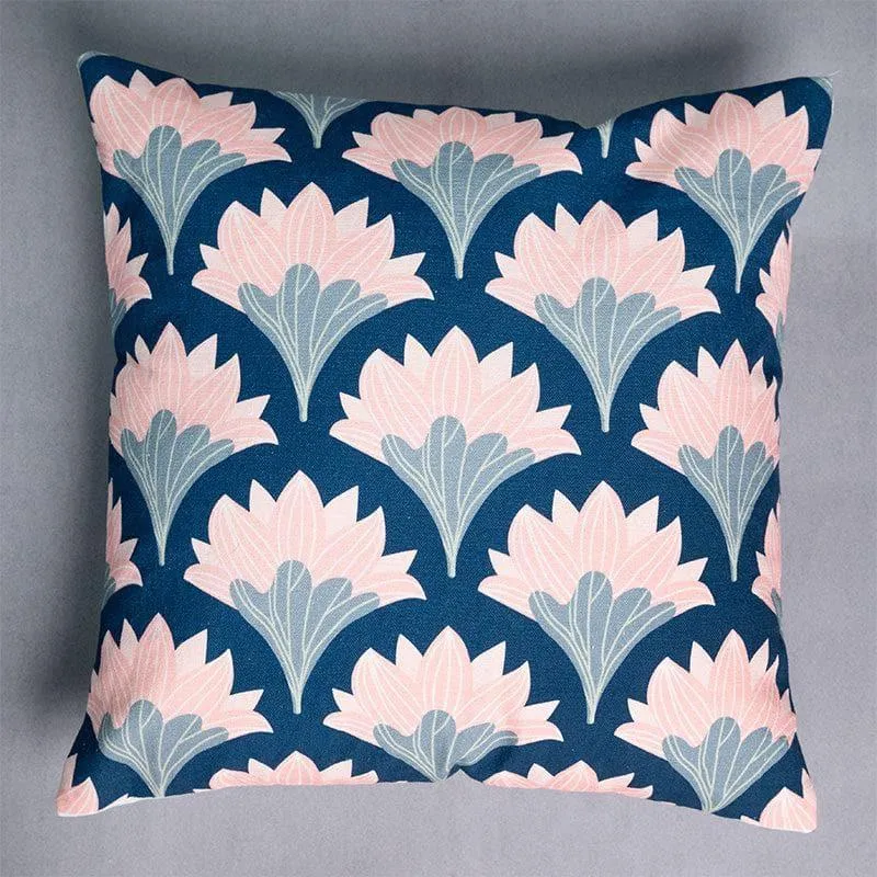 Close-up of a square cushion cover with a repeating pink and blue floral pattern.