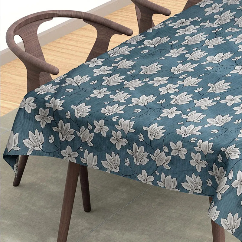 Close-up view of the blue and white floral table cover on a dining table