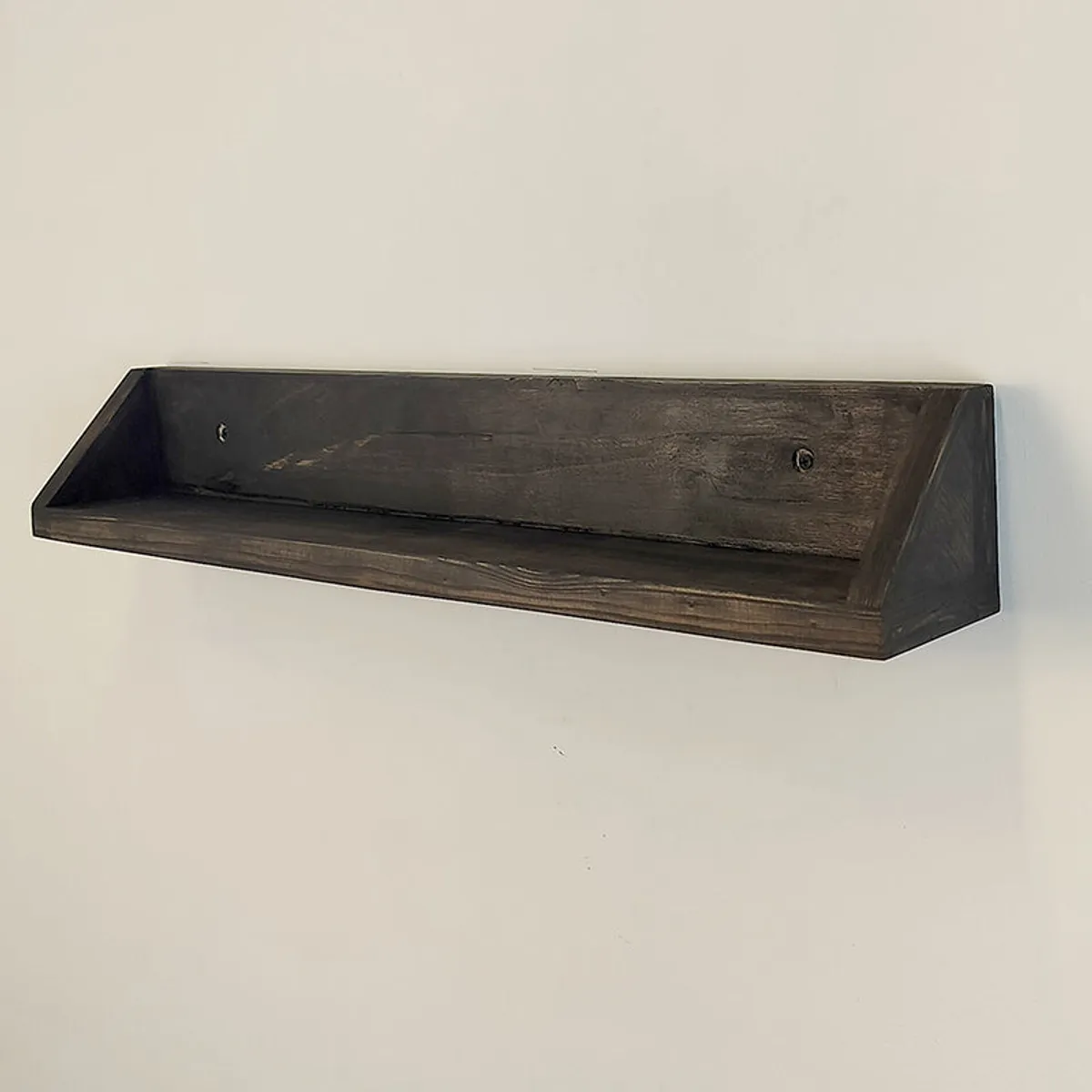 Empty brown wooden wall shelf showing its open storage surface and wall-mount holes.