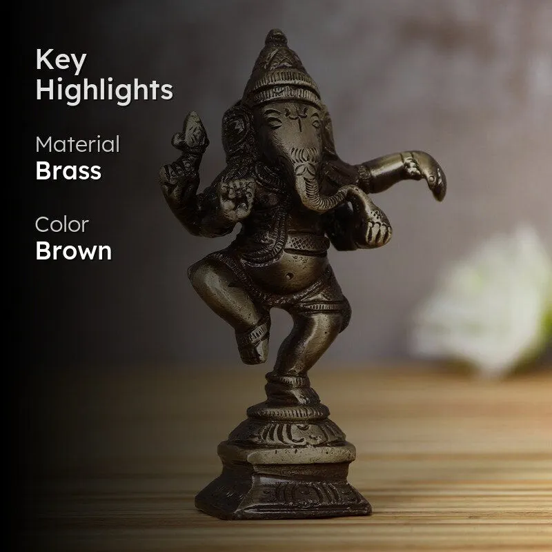 Brass Ganesha idol on a tabletop with dark background