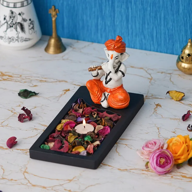 Ganesha tea light holder displayed on a tabletop with lit candle