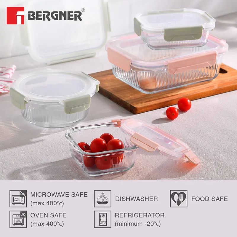 Several rectangular and round glass storage boxes with green and peach lids