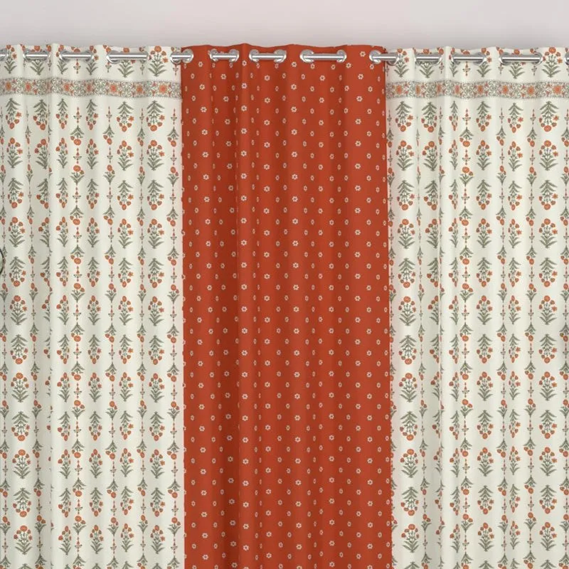 Close view of eyelet-hung curtains with rust and off-white printed panels