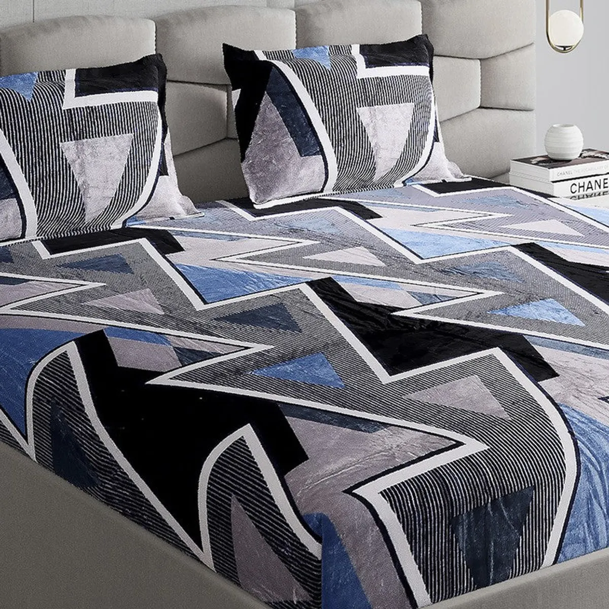 Close-up of blue, black and grey geometric triangle pattern on the bedsheet