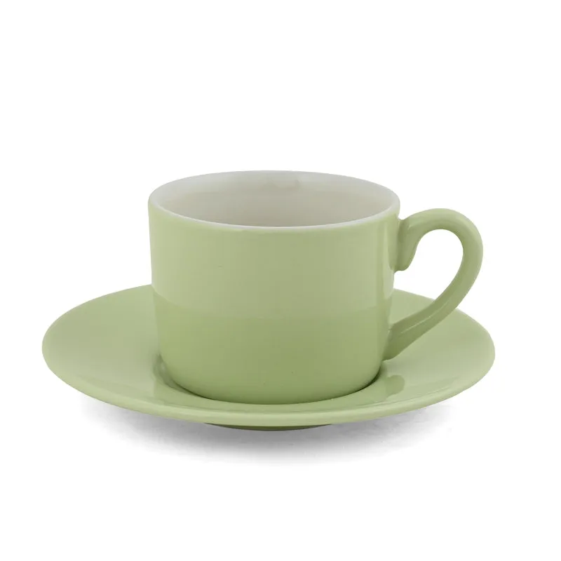Single green cup resting on a matching saucer