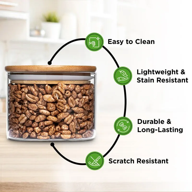 A transparent jar with a bamboo lid containing dry snacks, shown in a bright kitchen setting.