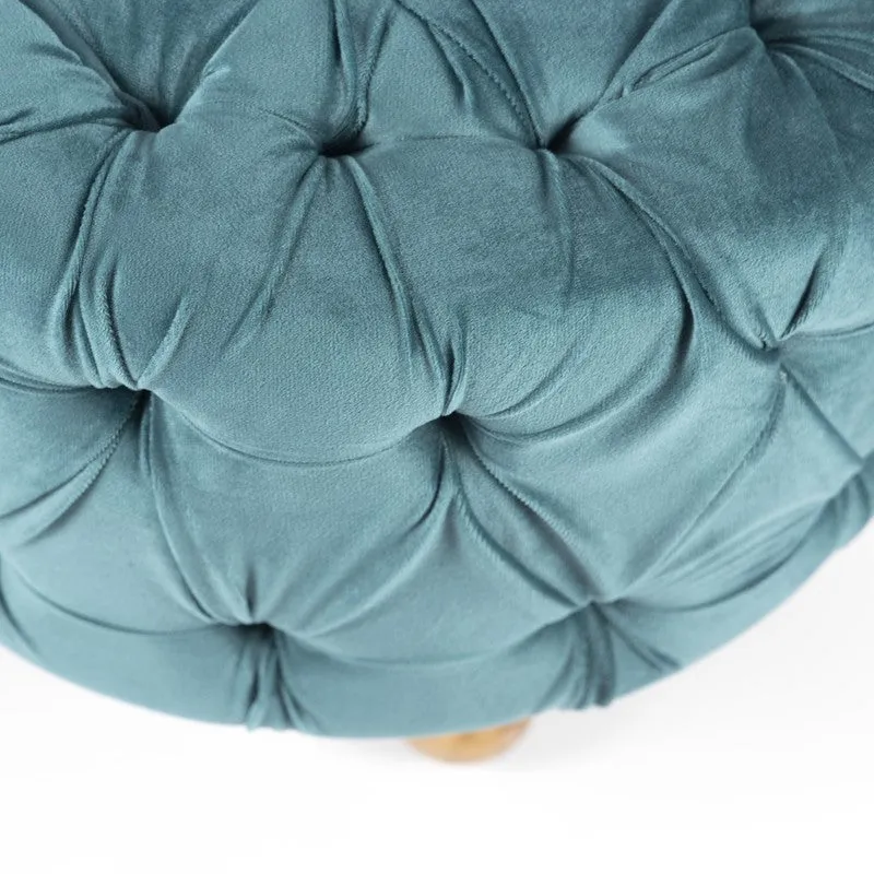 Close-up of blue tufted upholstery on ottoman