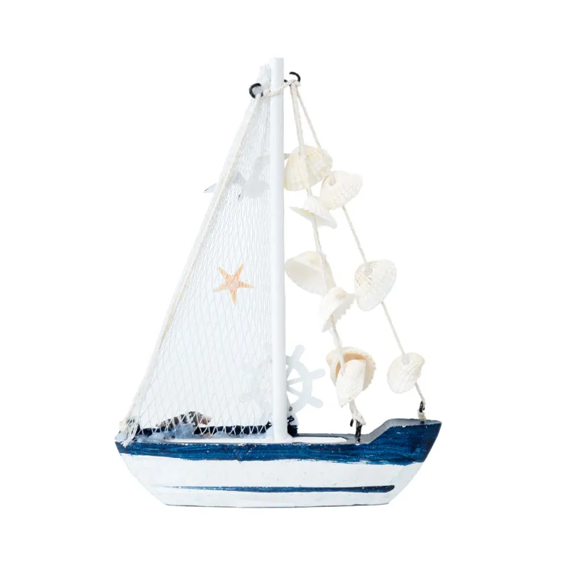 Side view of a white and blue sailboat showpiece with shell accents