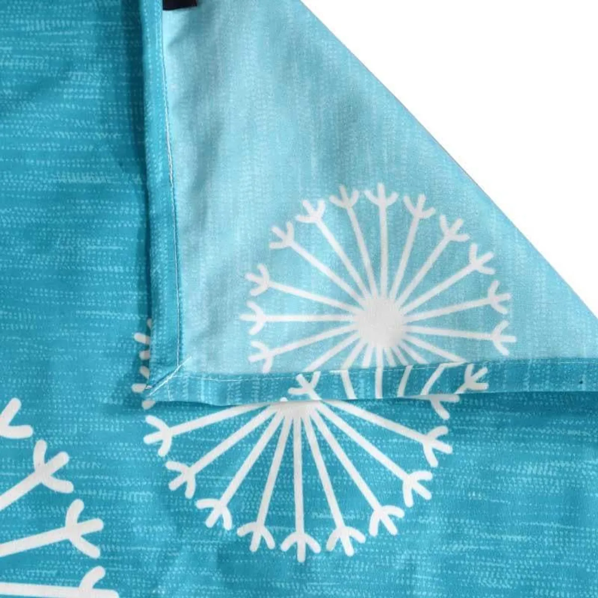 Close-up of blue fabric and a white dandelion print