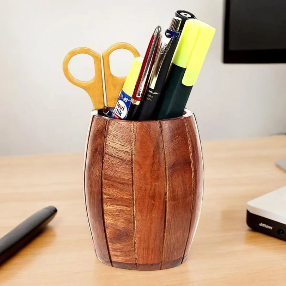 Brown wooden holder containing pens, scissors and desk supplies