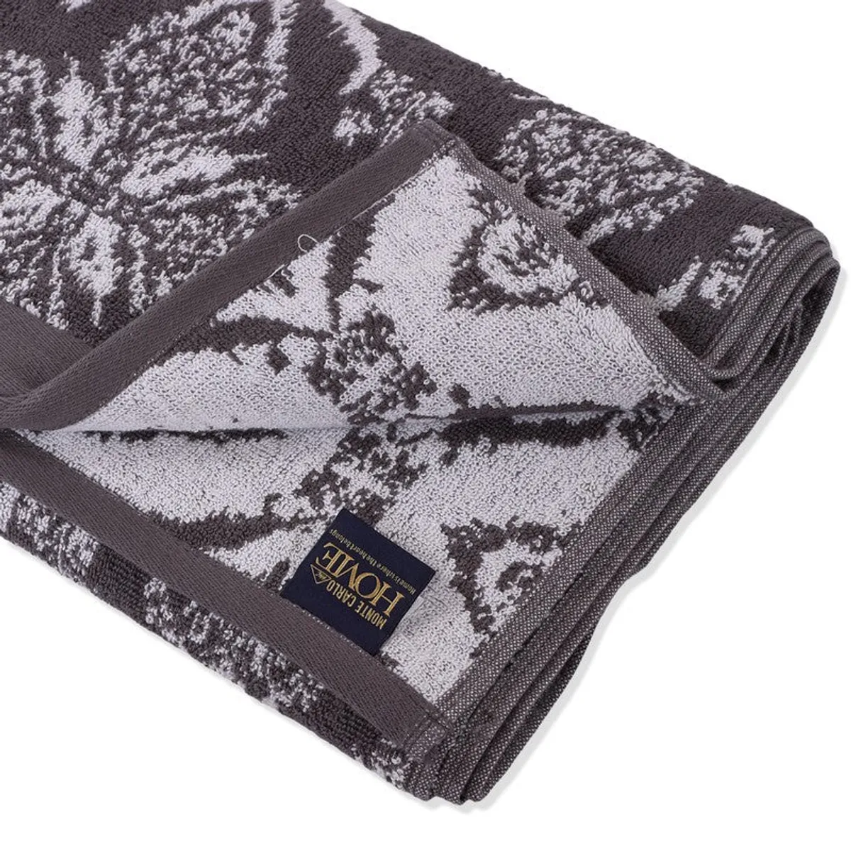 Close-up of the folded towel showing its floral texture and label