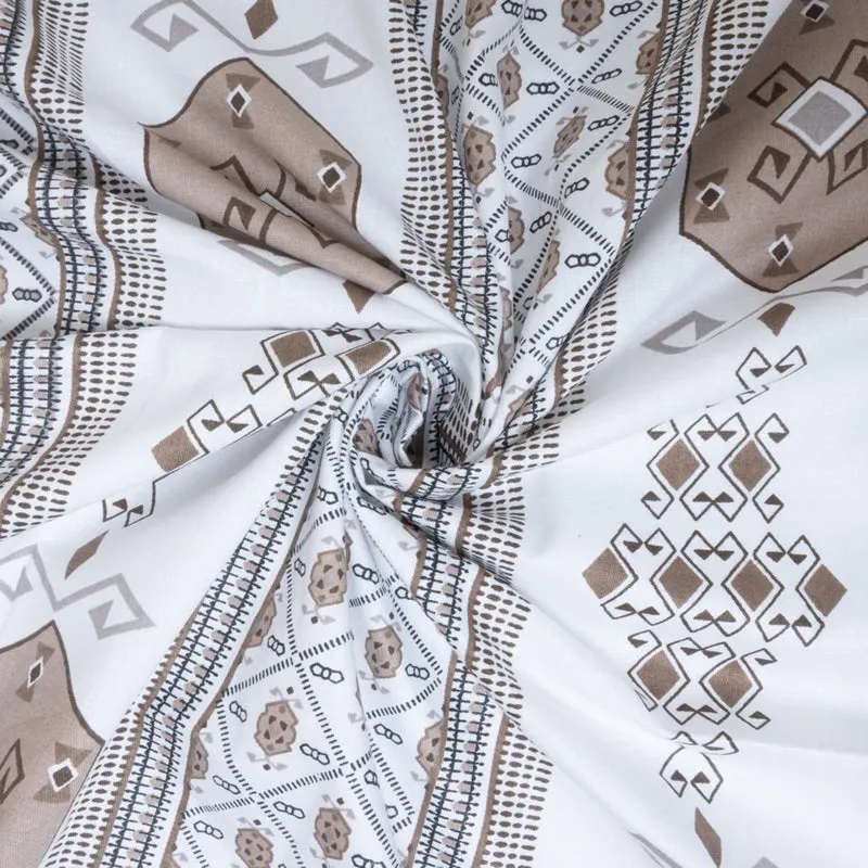 Close-up of the white and brown bedsheet fabric gathered to show the geometric print.
