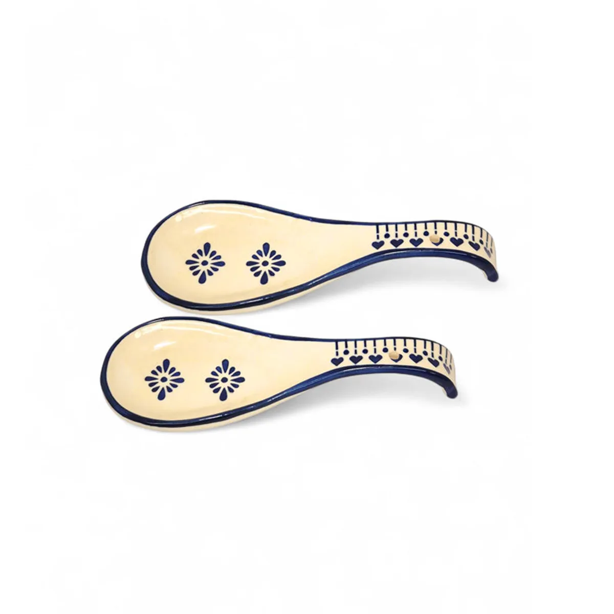 Pair of curved ceramic spoon rests with blue floral detailing on white background