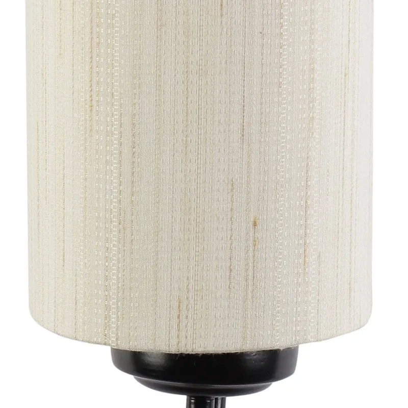 Close-up of beige textured cotton shade and black metal holder