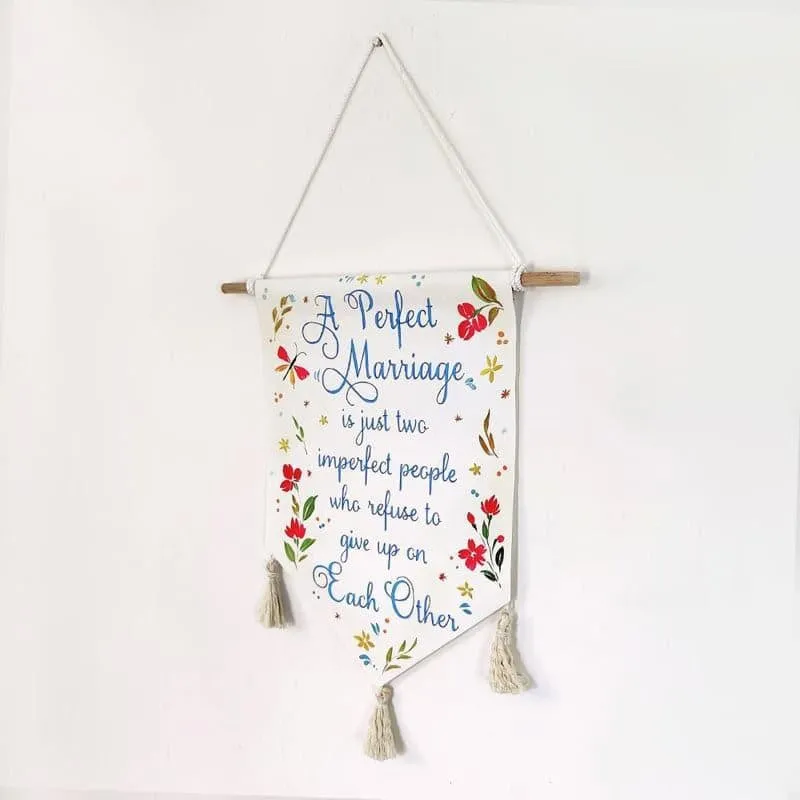 Triangular marriage quote wall hanging with multicolour floral accents and tassels