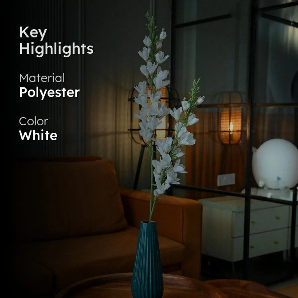 White artificial flower stick in a teal vase with material and colour highlights
