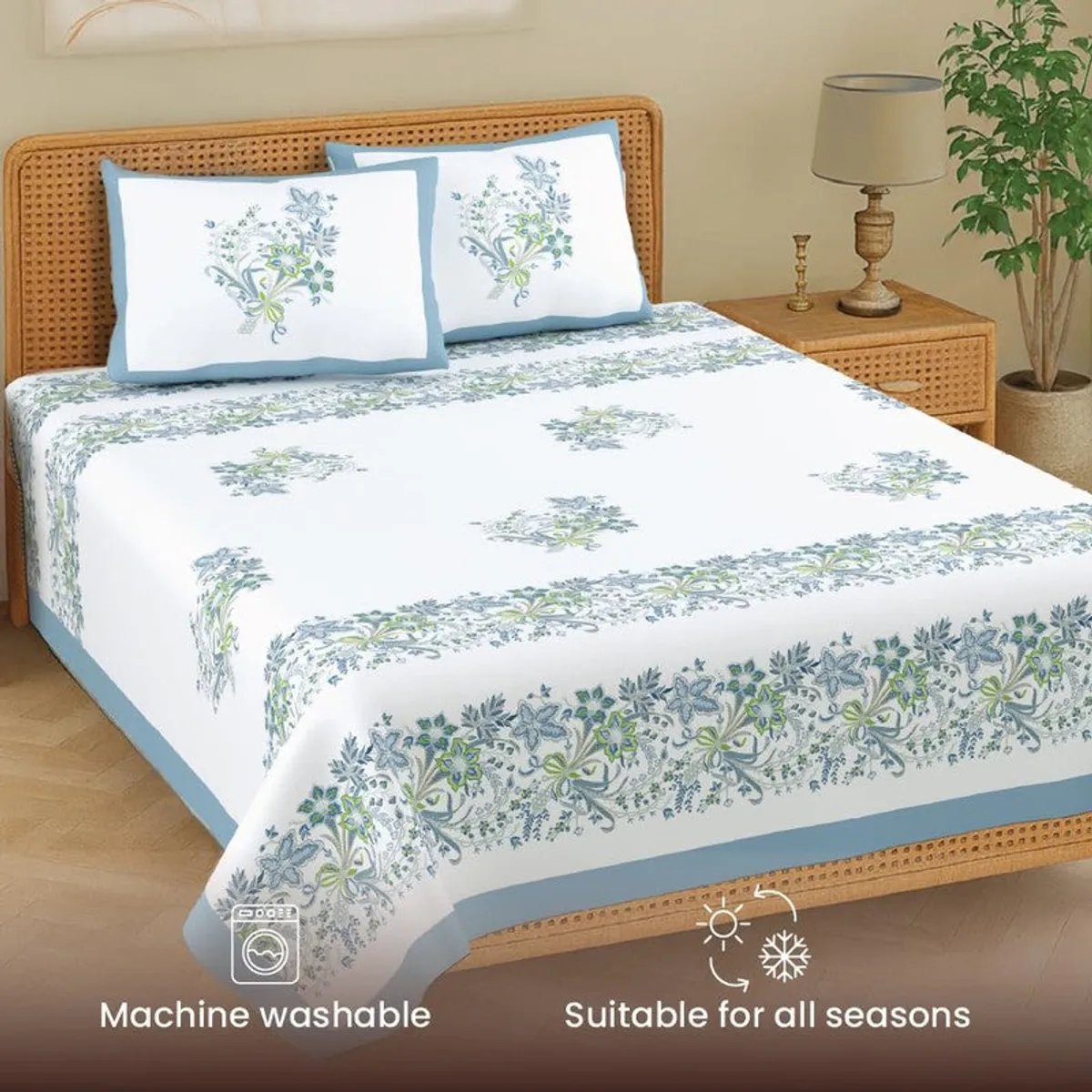Angled view of blue and white floral bedsheet with two matching pillow covers