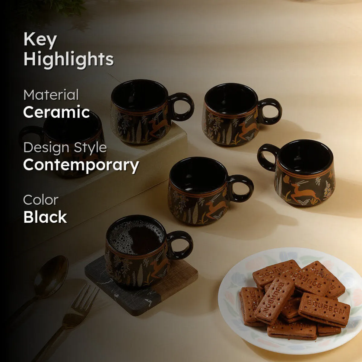 Black ceramic tea cups arranged on a table with wildlife detailing visible