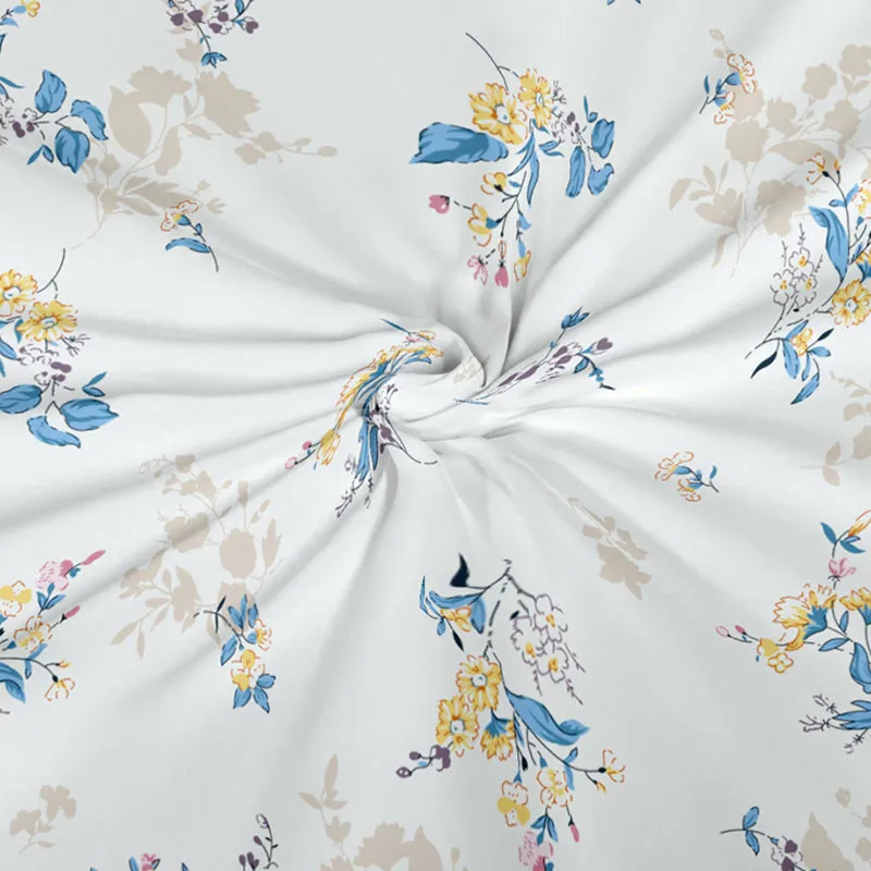 Close-up of white fabric with blue and yellow floral print