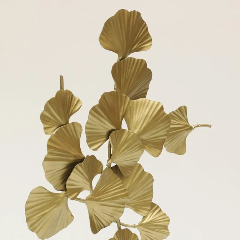 Close-up of a gold leaf-inspired decorative showpiece against a plain background