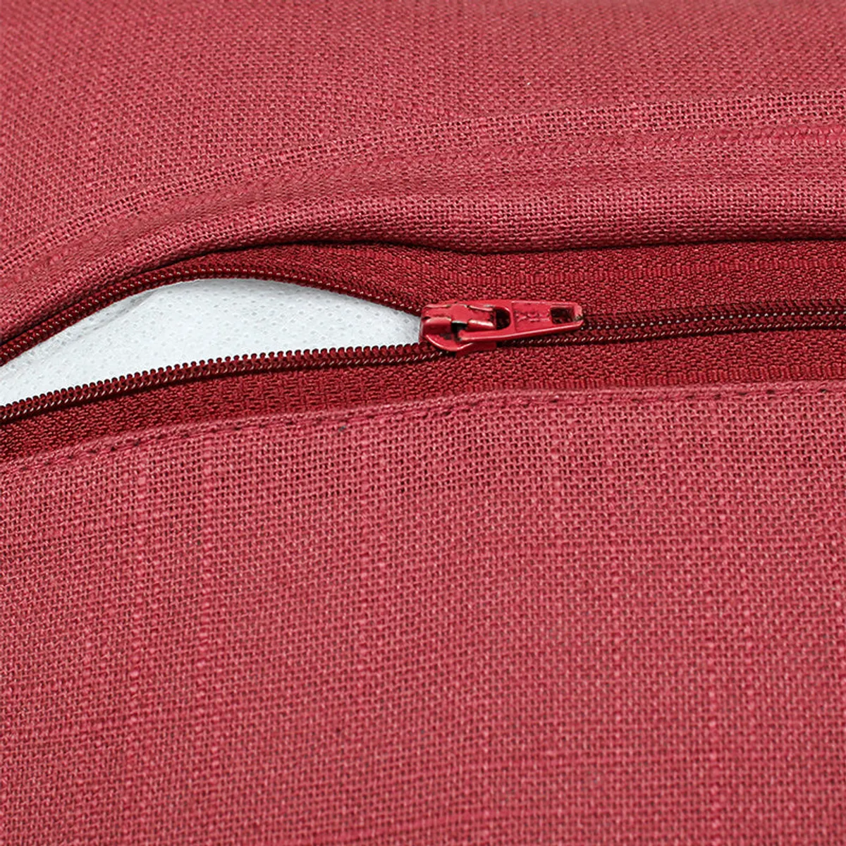 Close-up view showing the red textured cotton surface and zip closure