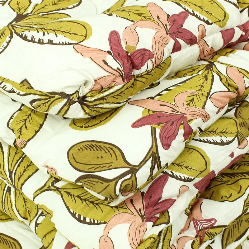 Detailed view of the comforter's floral printed surface and soft quilting