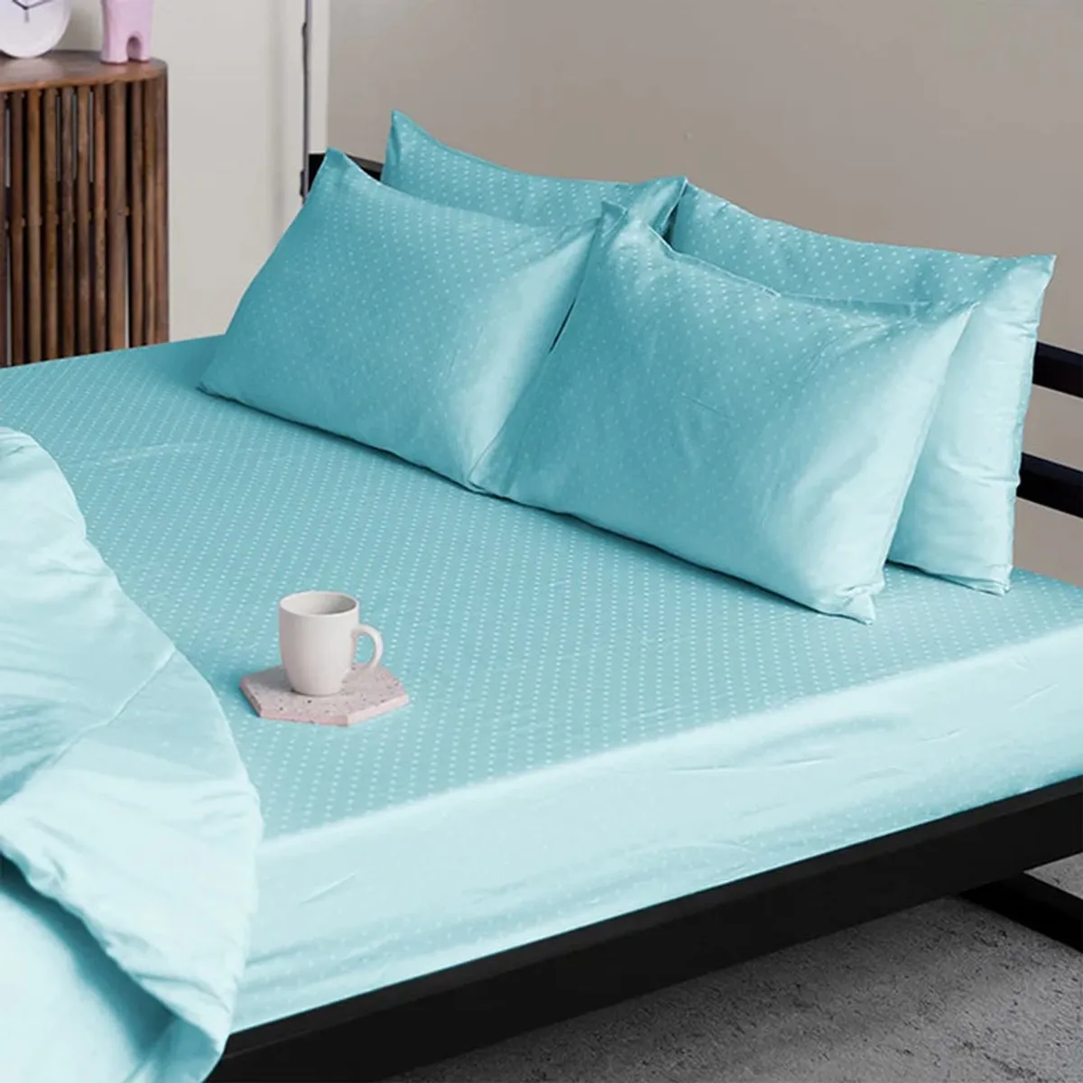 Sky-blue fitted bedsheet and matching pillow covers with a subtle geometric pattern