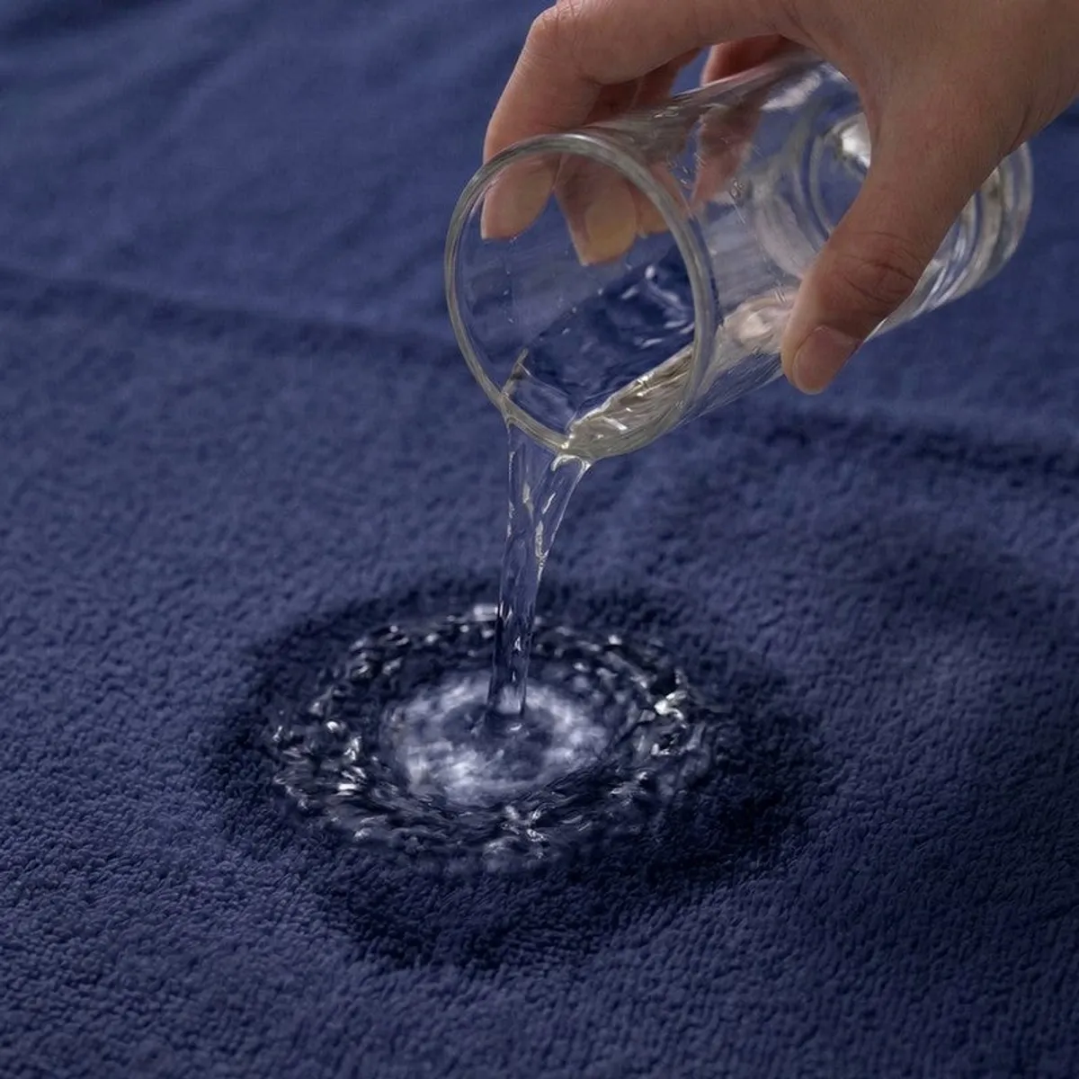 Water poured onto a blue towel to show absorbent fabric