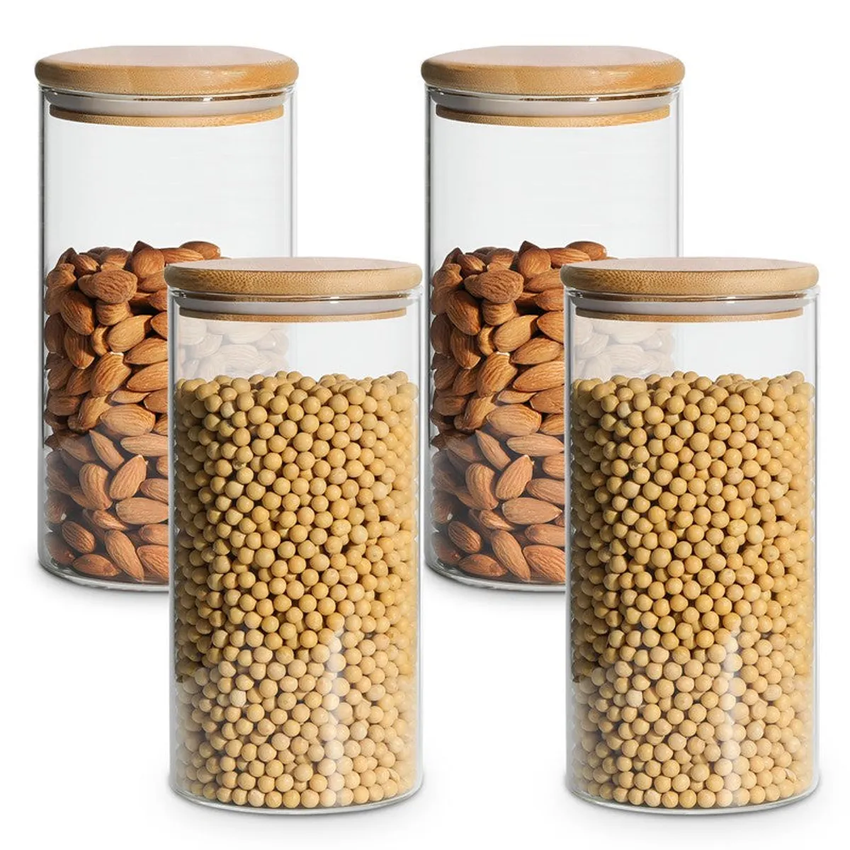 Four clear glass storage jars with bamboo lids shown with pulses and dry fruits.