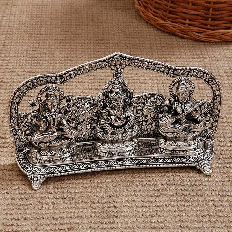 Front view of an ornate silver-toned Lakshmi Ganesha Saraswati idol