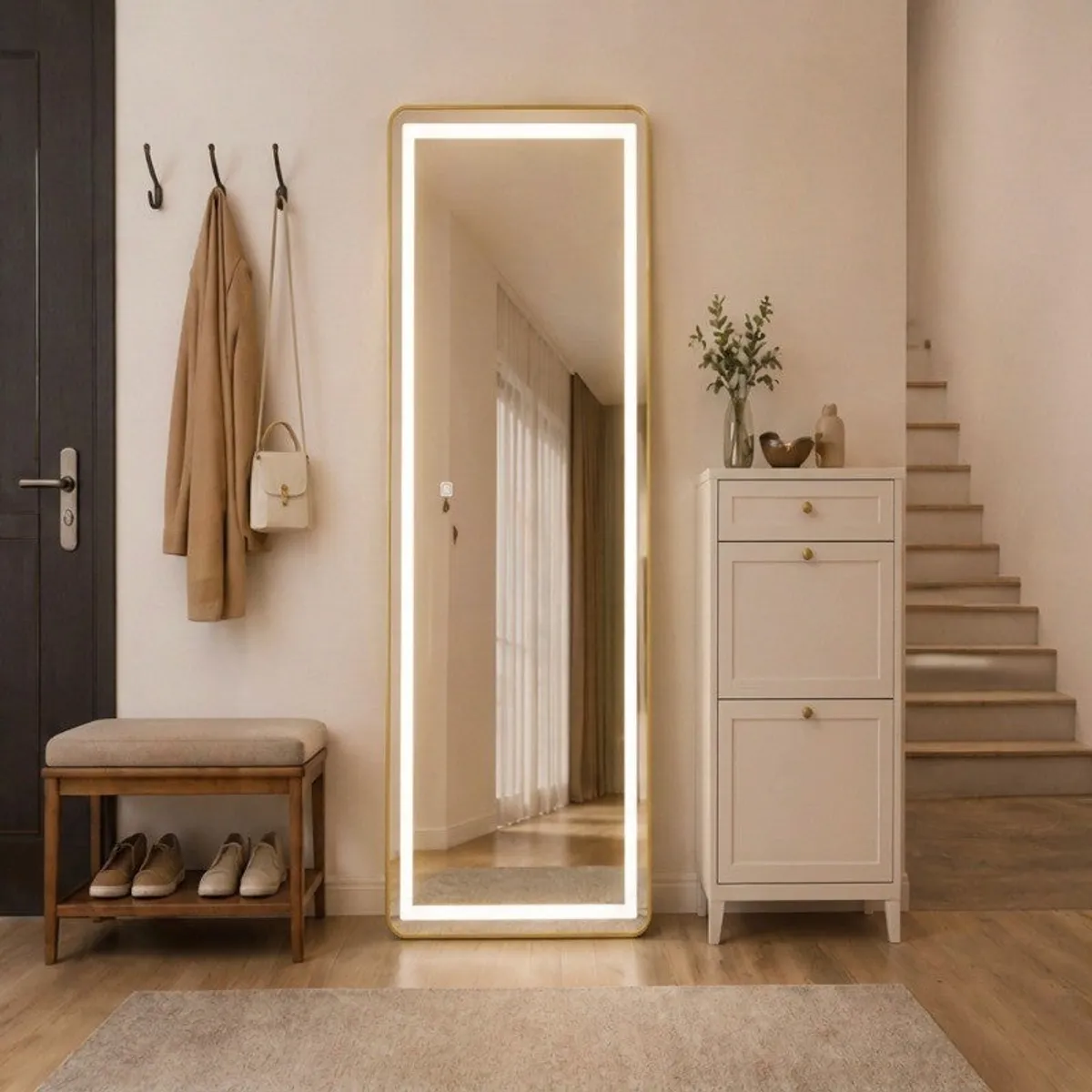 Illuminated gold floor mirror in a hallway beside a cabinet