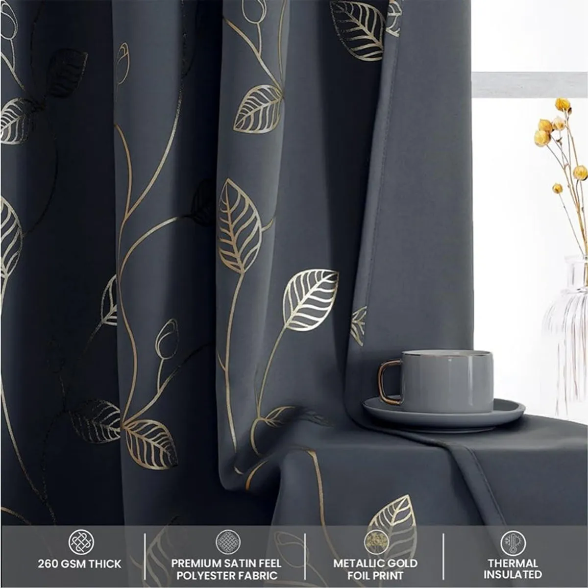 Close-up of dark curtain folds with contrasting gold and silver leaf motifs.