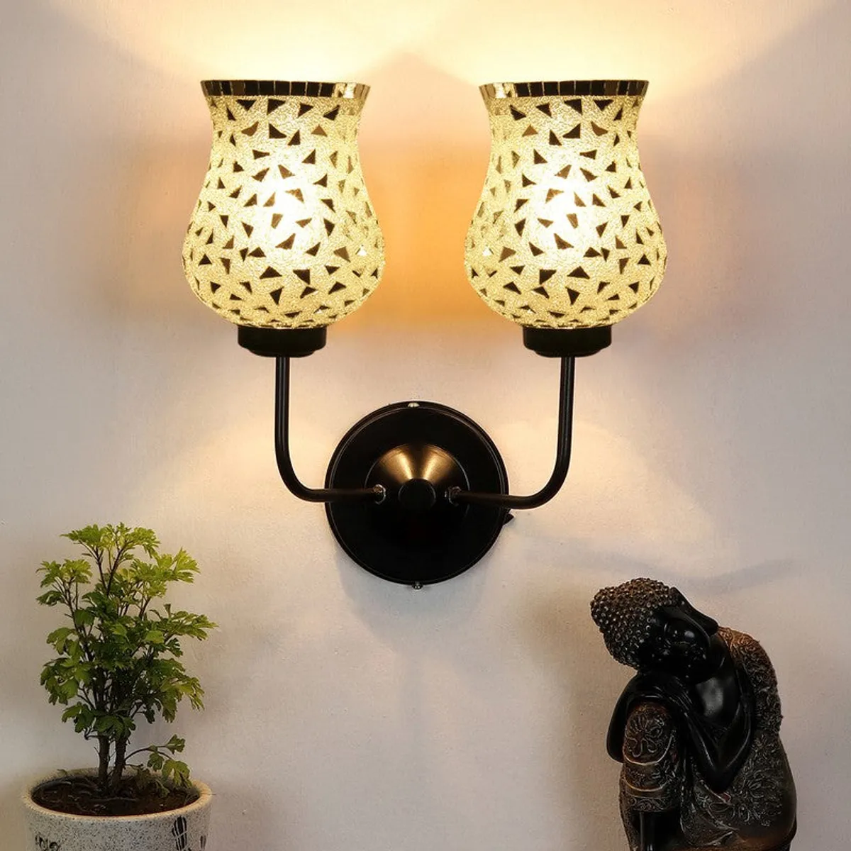 Twin silver mosaic glass wall lamp on black wall mount, illuminated